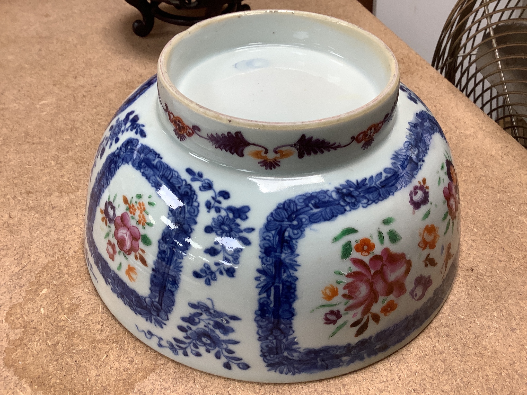 A 18th century Chinese export porcelain footed punch bowl on hardwood stand, diameter 20cm, restored